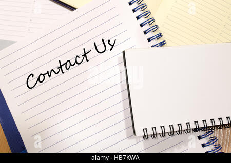 Contact us write on notebook Stock Photo
