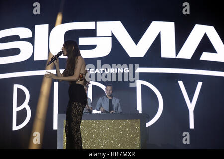 Singer Birdy performs with Sigma on stage at Capital's Jingle Bell Ball with Coca-Cola at London's O2 arena. Stock Photo