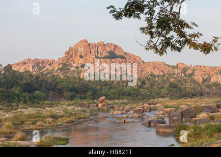 Tungabhadra River, Hampi, northern Karnataka, India with the region' with the region's particular rock formation in the distance Stock Photo