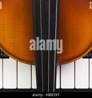 Very old violin lying on the piano Stock Photo