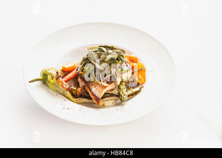 grilled sea bass with sage, asparagus, tomatoes, carrots and a chile Stock Photo