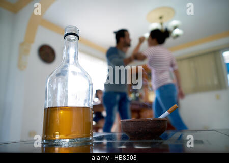 Social issues, abuse and violence on women, young drunk man hitting and beating girl at home after drinking alcohol. Angry husband fighting with abuse Stock Photo