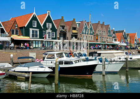 Motorboats at dock, houses along harbor, Volendam, North Holland Province, Holland, The Netherlands Stock Photo