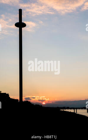 Silhouette of the British Airways i360 on Brighton beach at sunrise Stock Photo