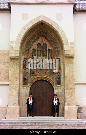 Guards in traditional dress stand guard at the entrance to St. Mark's Church in Zagreb. Stock Photo