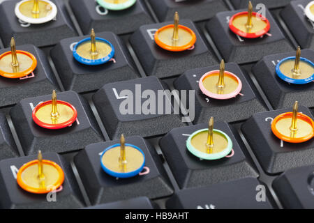 Pins on computer keyboard Stock Photo