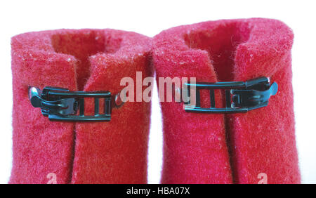 Iron clasps on the felt red boots Stock Photo