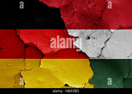 flags of Germany and Hungary painted on cracked wall Stock Photo