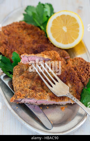 Piece of beef schnitzel on a fork. Stock Photo