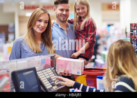 Family packing shopping at supermarket checkout Stock Photo