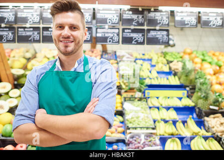 Portrait of sales clerk in grocery store Stock Photo