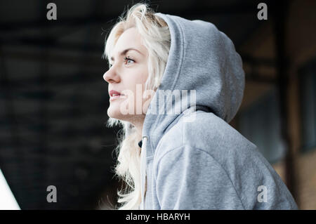 Portrait of mid adult female runner in grey hoody Stock Photo