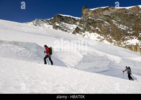 Mountaineers ski touring on snow-covered mountain, Saas Fee, Switzerland Stock Photo