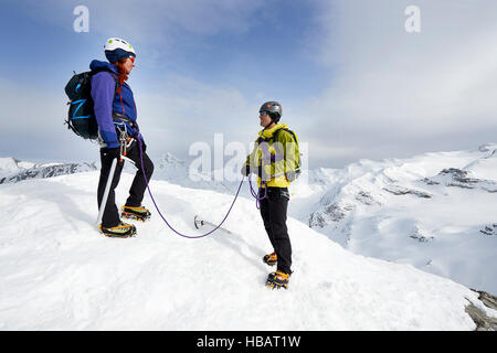 Mountaineers on top of snow-covered mountain, Saas Fee, Switzerland Stock Photo