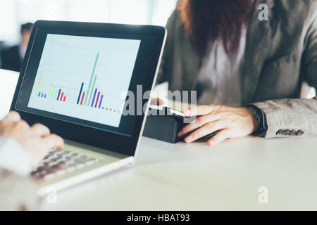 Cropped shot of young men using laptop and digital tablet at desk Stock Photo
