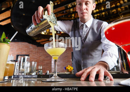 Bartender pouring cocktail Stock Photo