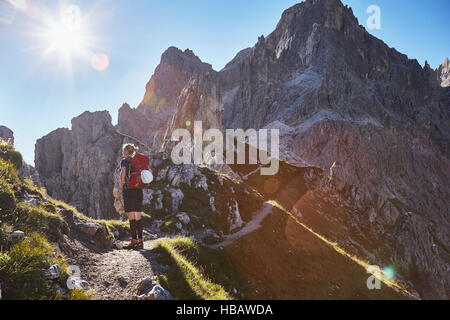 Rear view of female hiker hiking in Dolomites, Sexten, South Tyrol, Italy Stock Photo