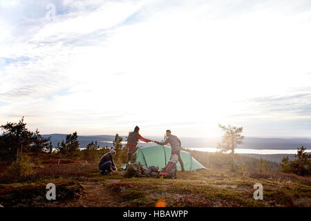Hikers setting up tent, Keimiotunturi, Lapland, Finland Stock Photo