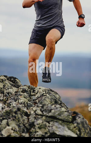 Man running on rocky cliff top, Keimiotunturi, Lapland, Finland Stock Photo