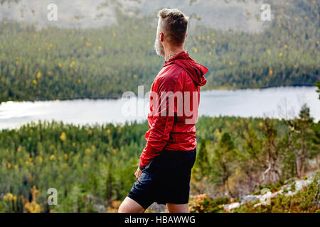 Hiker enjoying view on steep hill, Kesankitunturi, Lapland, Finland Stock Photo