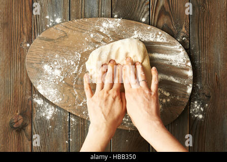 Female hands kneading dough Stock Photo