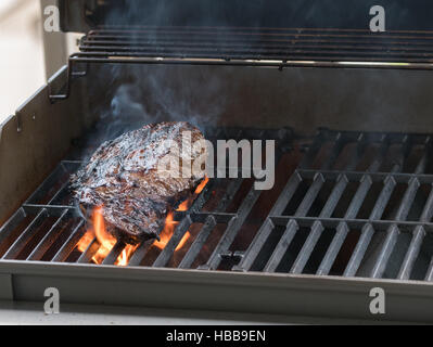 Large fillet of beef flaming on barbeque Stock Photo