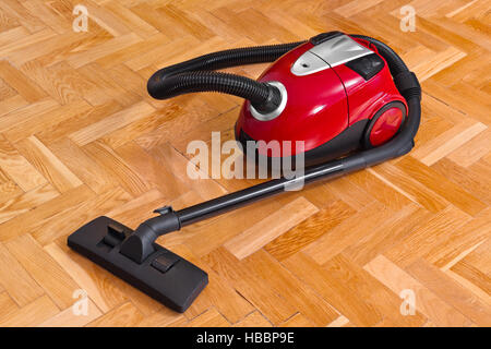 Vacuum cleaner on parquet Stock Photo