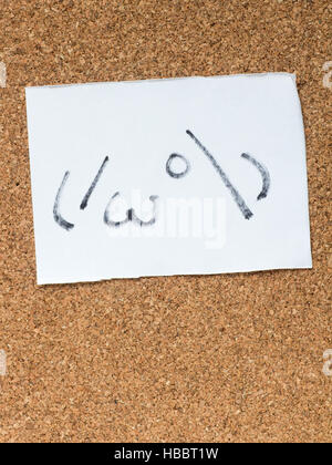 The series of Japanese emoticons called Kaomoji on the cork board, peeking Stock Photo