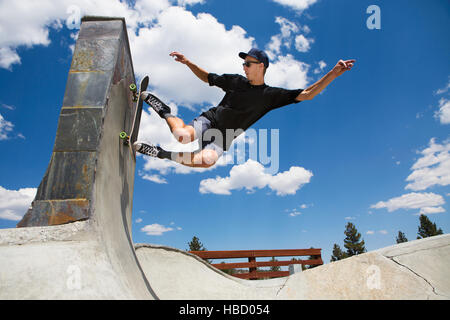 Young man skateboarding in skate park ramp, Mammoth Lakes, California, USA Stock Photo