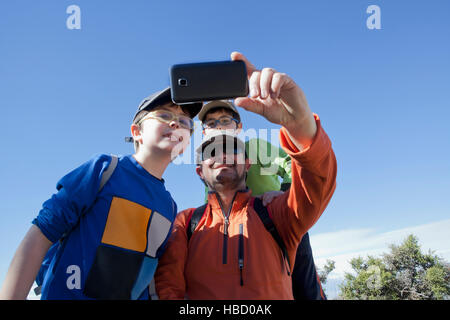 Man and twin sons taking smartphone selfie in Andes, Valparaiso, Chile Stock Photo