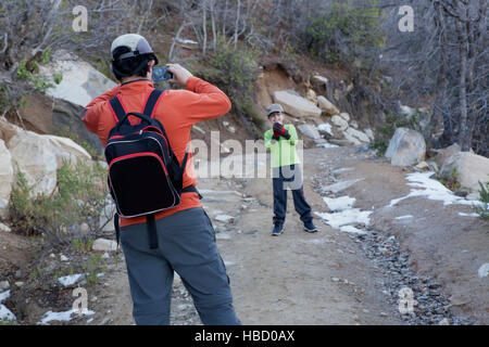 Man photographing son holding snowball in Andes, Valparaiso, Chile Stock Photo