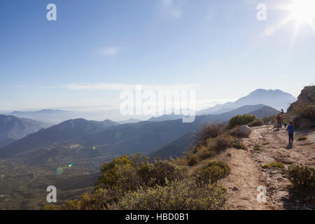 Rear view of man and two sons hiking dirt track in Andes, Valparaiso, Chile Stock Photo