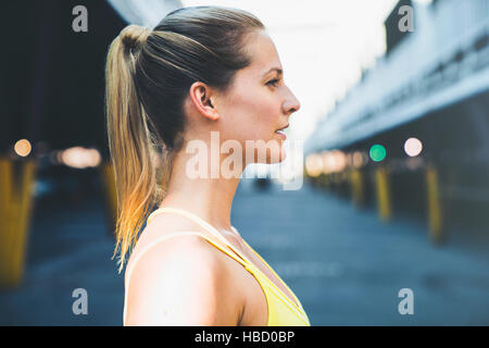 Profile of young woman in sports vest Stock Photo