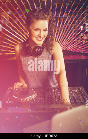 Composite image of pretty female dj playing music Stock Photo