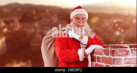 Composite image of portrait of santa claus with eyeglasses carrying bag full of gifts Stock Photo