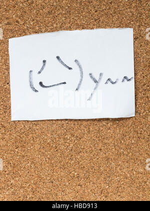 The series of Japanese emoticons called Kaomoji on the cork board, smoking Stock Photo