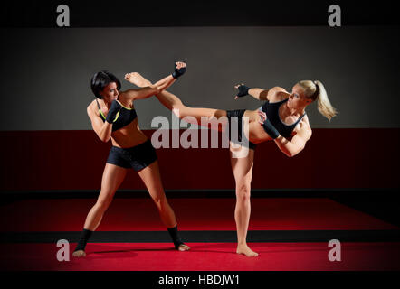 Two kickboxers women in sports hall Stock Photo