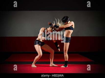 Two kickboxers women in sports hall Stock Photo