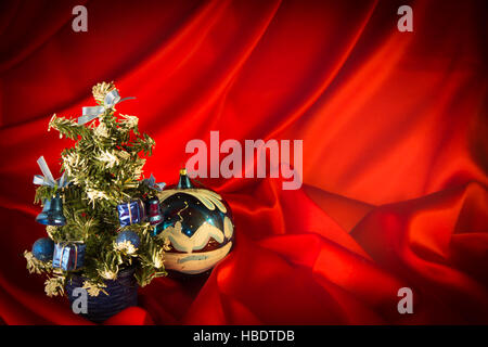 fiery-red background for congratulations on Christmas and New Year with different toys Stock Photo