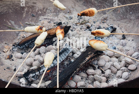 Stock bread is grilled over a campfire Stock Photo