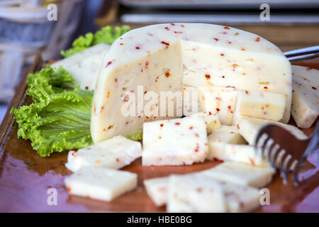 Italian cheese with hot chili pepper . Stock Photo