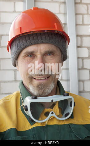 An elderly worker in protective helmet Stock Photo