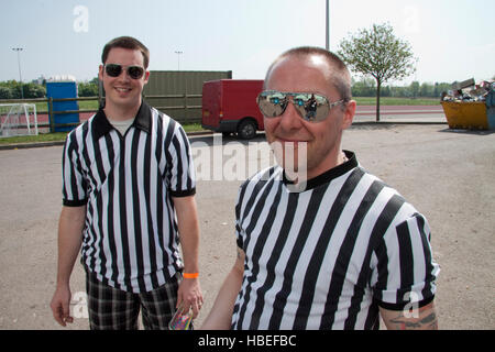 Two male roller derby refs wearing sunglasses outside on a sunny day Stock Photo