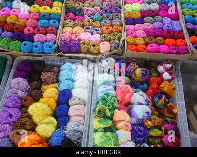 Variety of colorful wool yarns in baskets Stock Photo