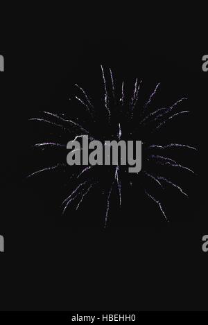 Shiny natural fireworks on dark black sky background with a little smoke Stock Photo