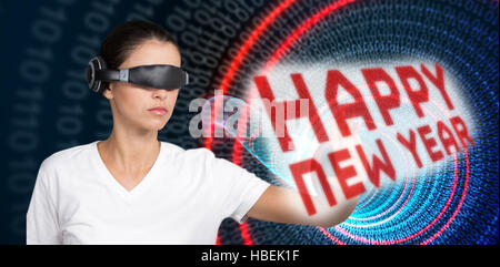 Composite image of beautiful woman gesturing while using virtual video glasses Stock Photo