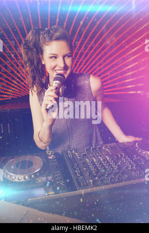 Composite image of pretty female dj playing music Stock Photo