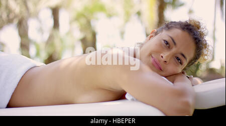 Woman on massage table looking up Stock Photo