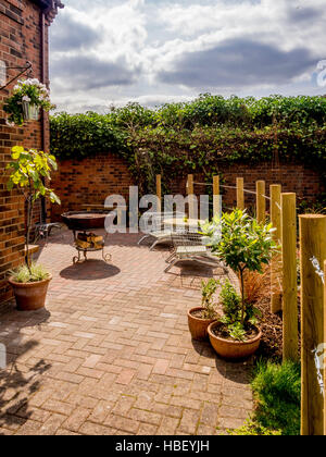 Garden areas divided using wooden stakes to create outdoor rooms in modern contemporary design Stock Photo