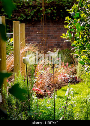 Garden areas divided using wooden stakes to create outdoor rooms in modern contemporary design Stock Photo